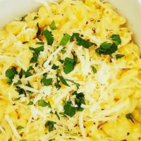 Mac And Cheese · Macaroni in a smoked Mozzarella and Parmesan cream sauce, topped with fresh herbs.