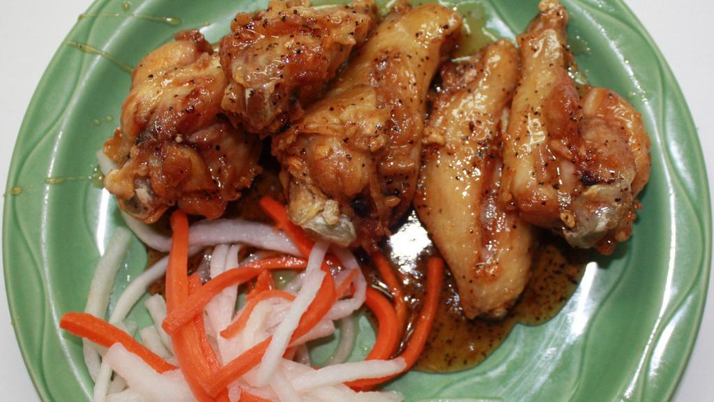 Caramelized Chicken Wings · Vietnamese style chicken wings caramelized in a garlic pepper marinade.