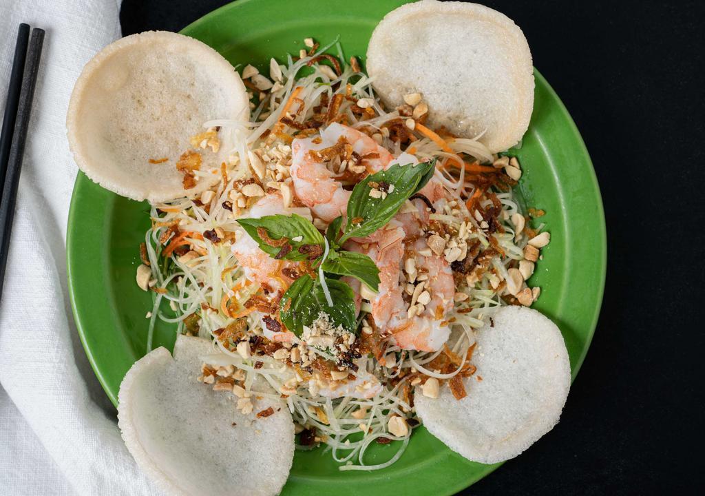 Green Papaya Salad · Hand cut green papaya, carrots, and mint. Topped with shrimp and served with shrimp crackers and peanuts.