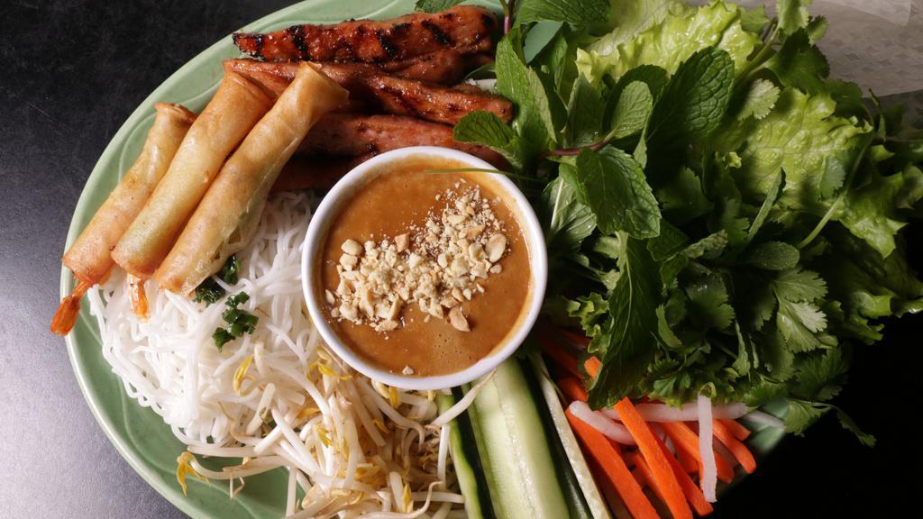 Vietnamese Pork Sausage · Grilled honey marinated Vietnamese pork sausage and crispy shrimp sticks. Served with rice paper and side of warm peanut sauce.