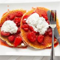 Topped Pancakes · Two pancakes topped with your choice of blueberry topping or strawberries with whipped cream.
