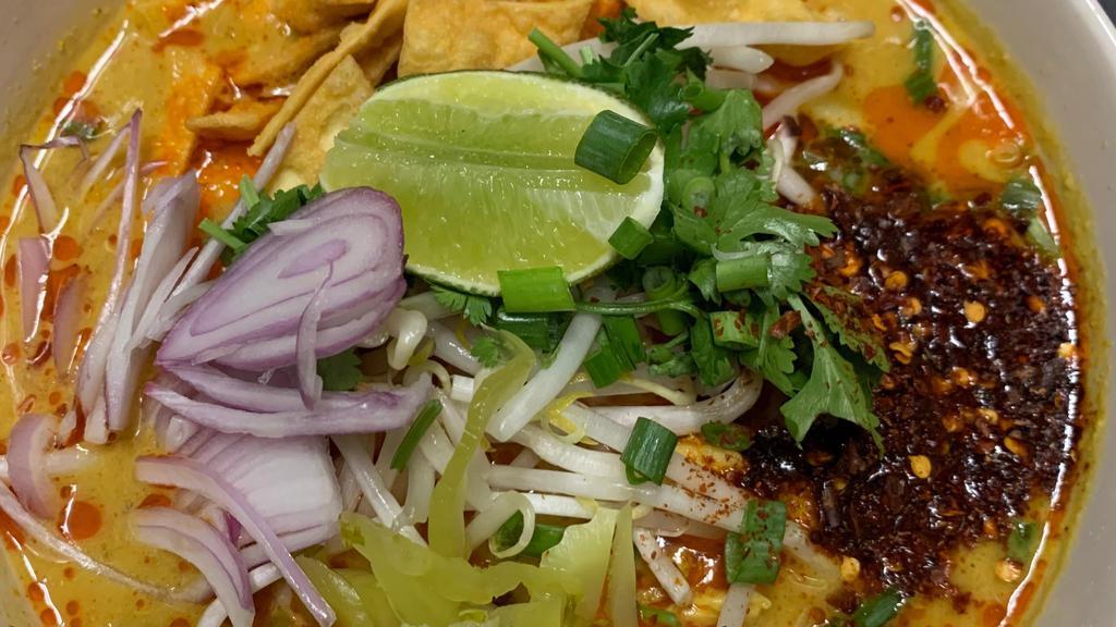 Khao Soi:* (Vg) · Famous Northern-style curry with Choice of Noodle, Soy Curls or Fresh Tofu, shallots, Thai pickled cabbage, and bean sprouts, green onion, and cilantro.