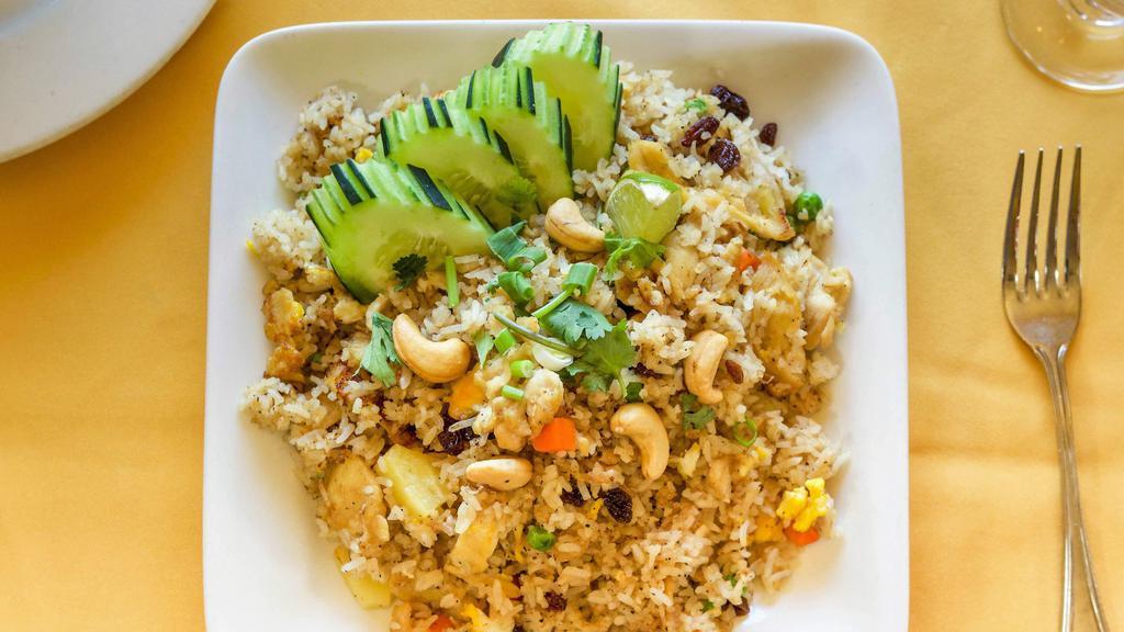 Hawaiian Fried Rice:(Vg) · Fried rice with protein, egg, pineapples chunks, raisins, cashew nuts, tomatoes, carrots, and green peas topped w/ cilantro and cucumber.