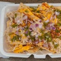 Nachos 1/2 · Corn tortilla chips with nacho cheese, pinto beans & sauce, any combination of meat salsa, o...