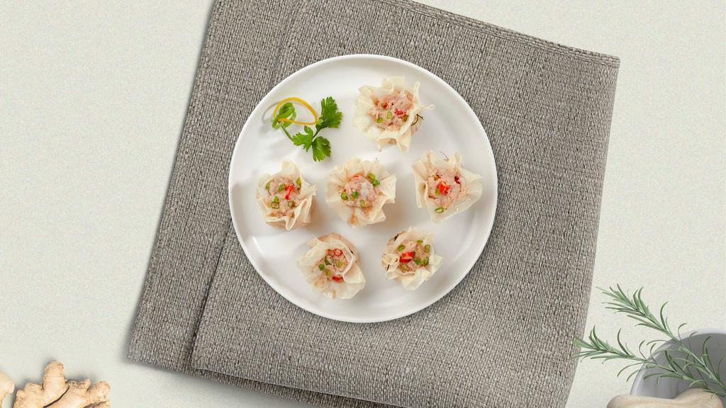Chinese Dumpling (Shumai) (4 Pcs) · Steamed house-made dumplings filled with shrimp, chicken, shiitake mushrooms, and water chestnuts. Served with our house-made ginger-soy sauce.