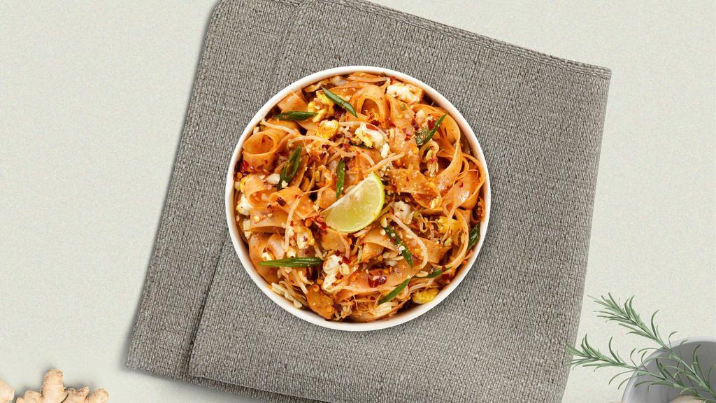 Pad Thai (Contains Peanuts) · Pan-fried thin rice noodles, egg, bean sprouts, and green onions in our house-made tamarind sauce topped with fresh bean sprouts, ground peanuts, and a wedge of lime.