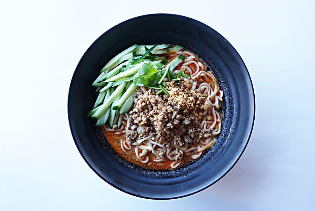 Dandan / 擔擔麵 · Hot. House-made wheat noodle in a heavier chicken broth with sesame paste, topped with minced pork, sliced cucumber, cilantro, and crushed peanut.