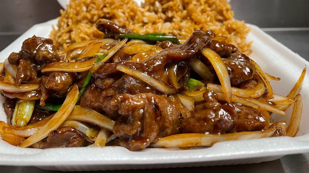 Mongolian Beef · Stir-fried sliced beef with onions in a mongolian sauce on a bed of rice noodles.
