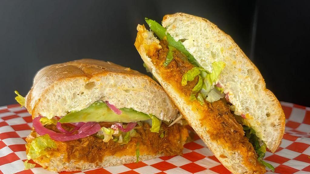 Torta De Pierna · Sandwich filled with pork, onions, tomatoes, lettuce, avocados and mayonnaise.