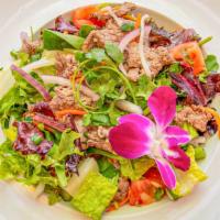 Beef Salad · Sliced beef, lettuce, red onion and tomato seasoned with spicy lime dressing.