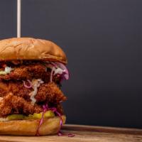 The Bad Chick Sandwich · This chick gets pounded, stacked three thighs high, pickles, topped with house made slaw, an...
