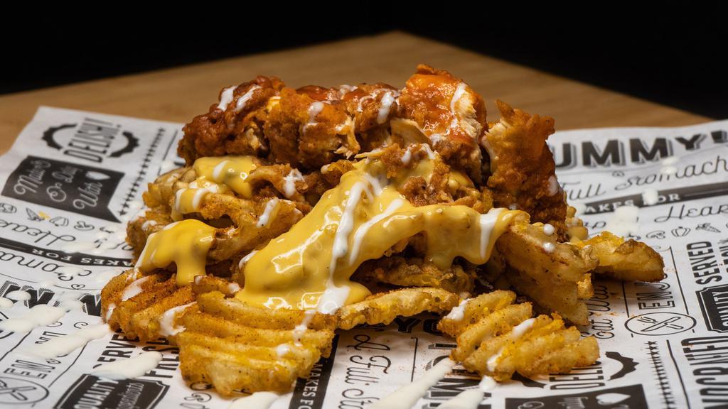 Buffalo Ranch Fries · Our Crispy Golden #Fries covered in Hatch Chile Cheese, Topped with a Side Chick drizzled with  buffalo and ranch sauce.