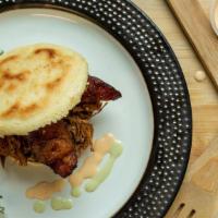 Pabellon Arepa · White corn bread with black beans, fried plantains, shredded beef sauteed with onions and sp...