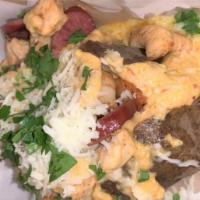 Spicy New Orleans Potato · Baked potato topped with grilled chicken, shrimp, beef sausage, spicy creamy alfredo sauce, ...
