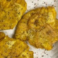 Tostones By The Pound · Tostones are crispy, hash brown-like rounds that are made from green plantains and then slic...