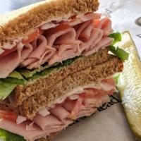 Smoked Ham Sandwich · 1/4 lb. Smoked ham, green leaf, Roma tomato, red onion, and mayonnaise. Choice of bread. Ser...