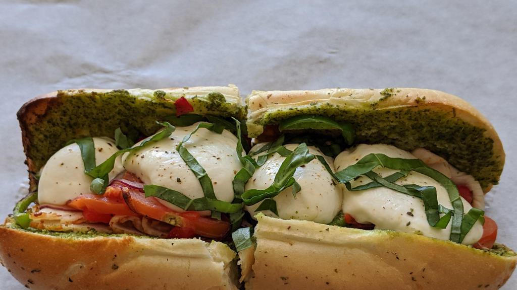 Edna Murray Aka The Kissing Bandit · 1/4lb. Sliced Chicken breast, basil pesto, Roma tomatoes, red onion, green bell peppers, cracked pepper, fresh mozzarella. Served hot on a toasted Sicilian hoagie topped with fresh basil. Pickle spear on the side.