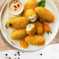 Holler Jalapeno Poppers · (Vegetarian) Fresh jalapenos coated in cream cheese and fried until golden brown.