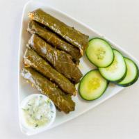 Dolma · 10 pcs of grape leaves stuffed with seasoned rice, tomatoes, onions, poblano peppers, garlic...