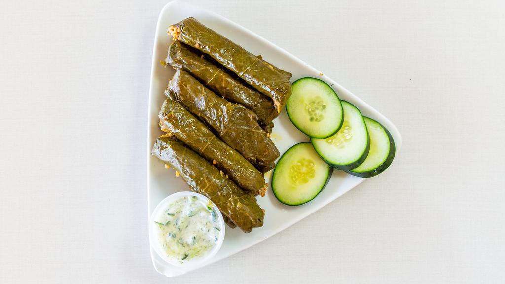 Dolma · 10 pcs of grape leaves stuffed with seasoned rice, tomatoes, onions, poblano peppers, garlic, parsley and celery wrapped and cooked to perfection.