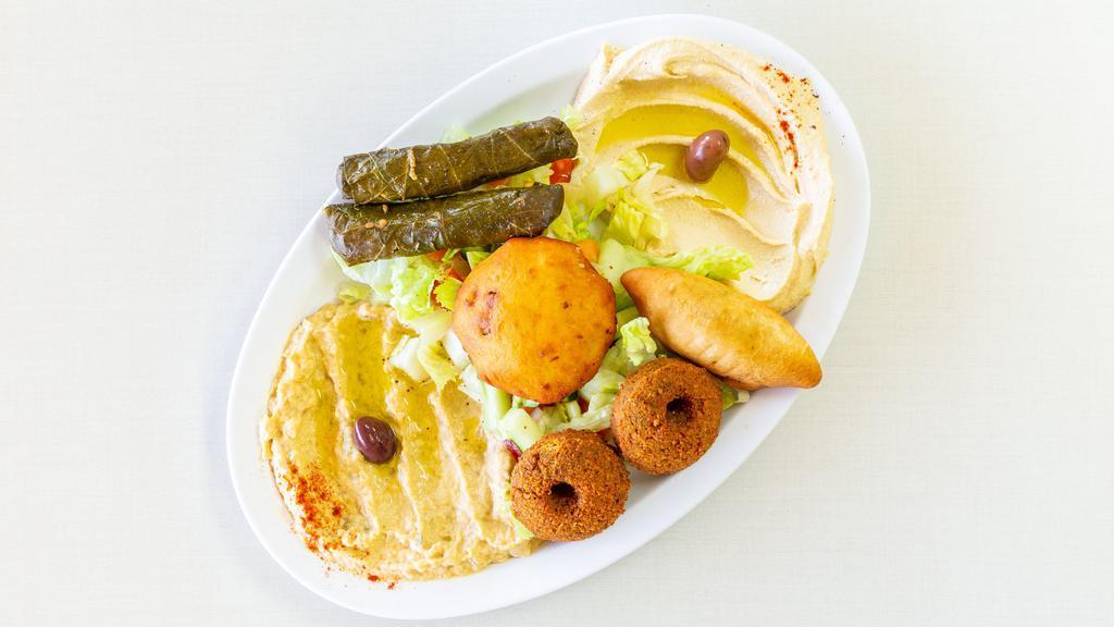 Veggie Platter · The ultimate sampler of hummus, baba ghanoush, potato cake, boorak, two pieces of falafel and salad.