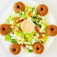 Falafel · Grounded chickpeas and fava beans with fresh herbs and spices deep-fried. Served with salad,...