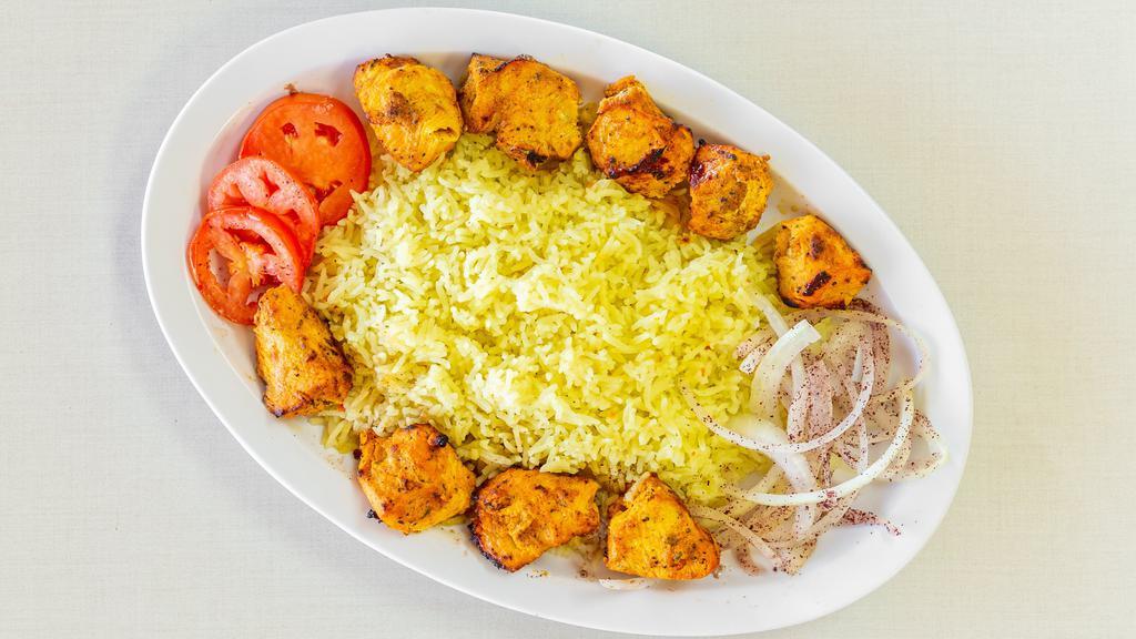 Chicken Kebab · Two (2) skewers of marinated chicken, char-broiled to perfection, served with rice, fresh slices of tomatoes and onions, pita bread and garlic sauce.