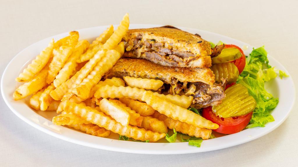 Gyro Panini · Slices of rotisserie gyro meat with grilled onions and American cheese, served with a side of tomatoes, lettuce, pickles and fries.