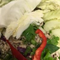 Larb Gai · Sautéed ground chicken mixed with fresh lime juice, hot pepper, green onion, cucumber and ci...