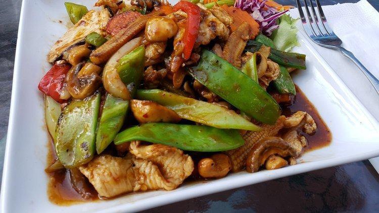 Cashew Chicken · Mild spicy. Sliced chicken stir fried with roasted cashew nuts, mushrooms, onions, carrots, baby corn, bell pepper and sweet chili sauce.    ≈ Spicy ≈