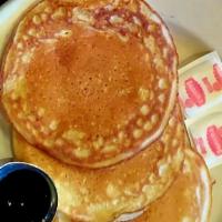 Pancake Breakfast · Three buttermilk pancakes, two eggs, bacon or sausage, breakfast potatoes or hash browns.