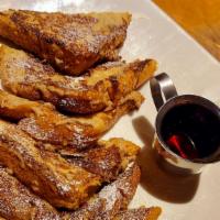 Classic French Toast · French toast with butter and maple syrup.