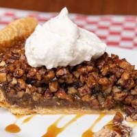Creole Pecan Pie · Toasted pecans & Steen's cane syrup custard baked in an all butter crust w/bourbon whipped c...