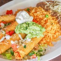 Taquitos Rancheros · 4 shredded chicken taquitos wrapped in flour tortillas, served with salad, pico de gallo, ri...