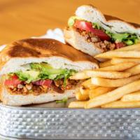 Torta · Mexican Style Sandwich: thin layer of beans, cheese, meat, tomato, lettuce, avocado, & mayo.