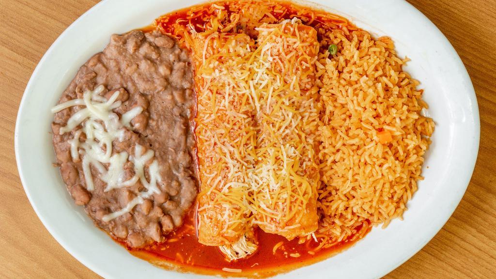 Enchiladas · 2 corn tortillas smothered in the sauce of your choice (Rojas/Suizas/Chipotle/Mole/a la Crema), filled with meat, topped with mozzarella cheese & sour cream. Served with rice, salad & refried pinto beans on the side.