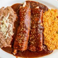 Enchiladas De Mole · 2 corn tortillas smothered in mole sauce filled with meat, topped with mozzarella cheese. Se...