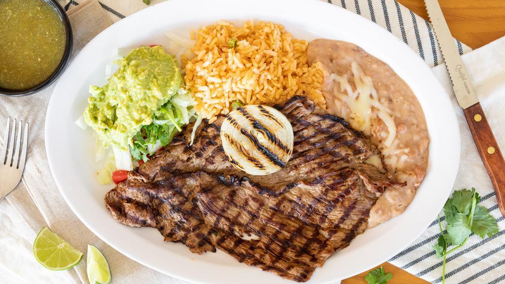 Carne Asada · Charbroiled steak served with rice, refried beans, salad, pico de gallo, grilled jalapeños & onions, freshly made guacamole & tortillas.
