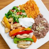 Chicken Fajitas · Marinated chicken breast sautéed with fresh bell peppers & onion. Served with rice, refried ...