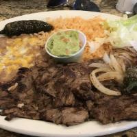 Carne Asada · A thin cut of authentically seasoned and grilled steak, guac on the side.