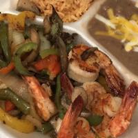 Camarones Al Mojo De Ajo · Garlic grilled jumbo shrimp served on a bed of bell peppers, onions, and mushrooms, flour or...
