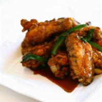 Phnom Penh Chicken Wings · Sautéed chicken wings with jalapeños and green onions in a sweet black pepper garlic sauce.