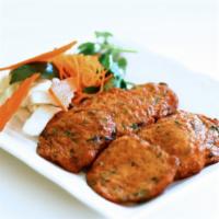 Prahut Jien · Cambodian fish cakes. White-fish meat infused with chili, lemongrass, and house spices. Deep...