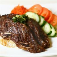 Cha-Ung Jom-Nee Sachko Aing · Grilled beef short ribs infused in a garlic, ginger, and lemongrass sauce.