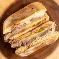 Salumi Cubano · Our slow roasted pork shoulder, sliced mustard salami, bread and butter pickles, dijon, and ...
