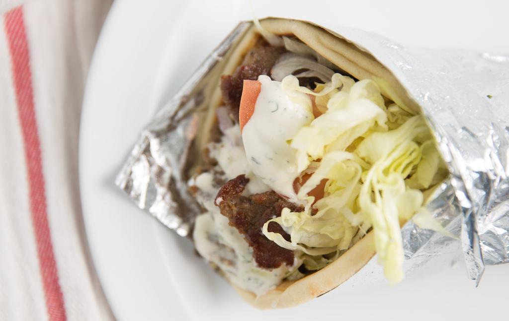 Lamb/Beef Gyro Pita · lettuce, tomato and onion wrapped in fluffy pita and topped with Tzatziki sauce.