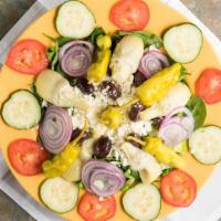 Greek Salad · Our Greek salad features romaine lettuce, spinach, tomatoes, cucumbers, Kalamata olives, art...