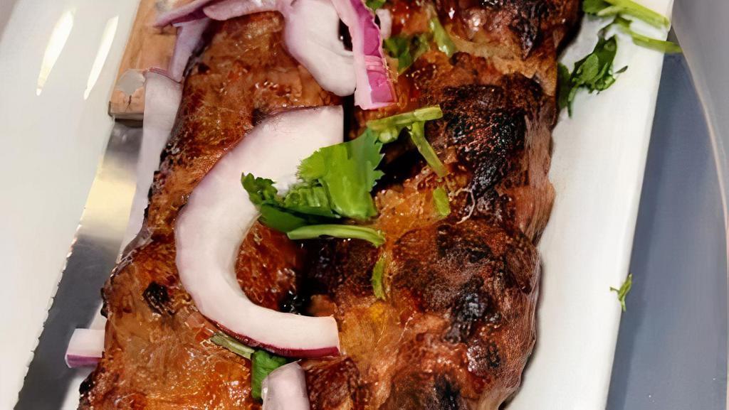 Beef Seekh Kebab (2) · Ground Beef, onions, cilantro and green onion roasted in a tandoor.