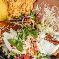 Chimichanga · Beef or chicken, deep-fried, topped with sour cream, Tomatoes, served with rice and beans.