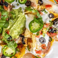 Nachos · Tortilla chips topped with beans, cheese, sour cream, guacamole (guacamole, contains dairy p...
